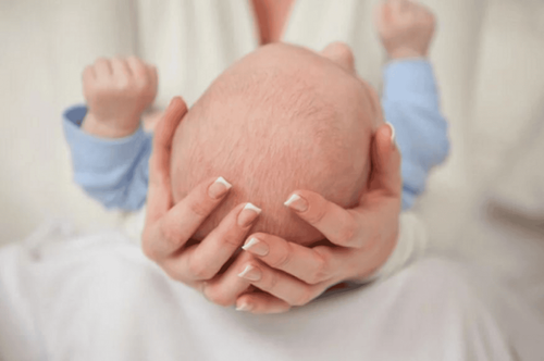 What should be noted about the ridge on the back of the baby's head?