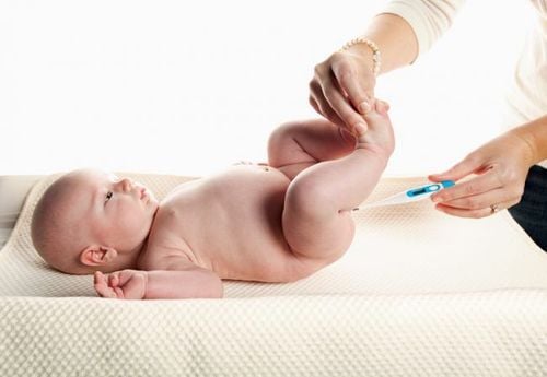 Checking a child’s temperature using an armpit or rectal thermometer.