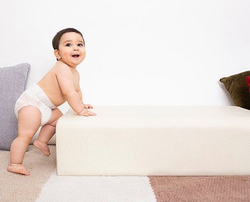 11-month-old babies tend to hold on to objects around them to stand up on their own.